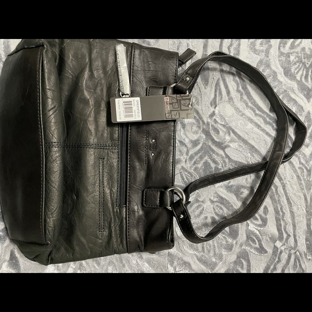 Black shoulder bag with silver accent. Genuine leather. NWT.
